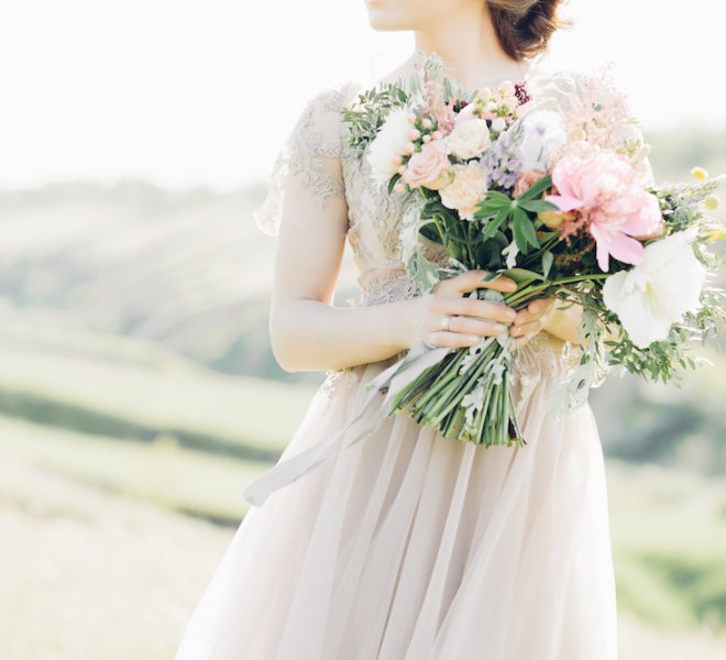 Portrait of beautiful bride with bouquet in nature. fine art photography.